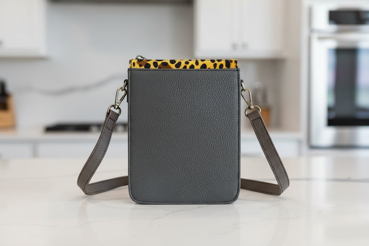 Gray leather crossbody bag with a strap reverse side