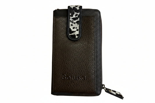 Brown leather wallet with a tag on a wooden surface
