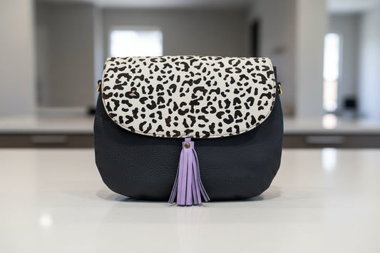 navy handbag with leopard print and purple tassel