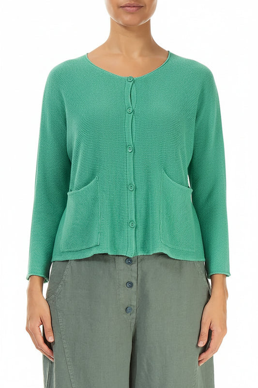 Green textured cardigan worn by a person on a white background