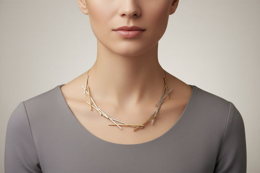 Silver necklace with interlocking bars on a dark background