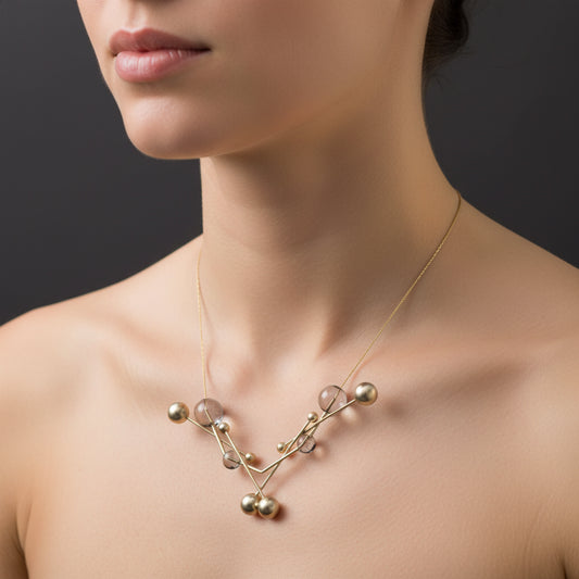Delicate necklace with spherical beads on a dark background
