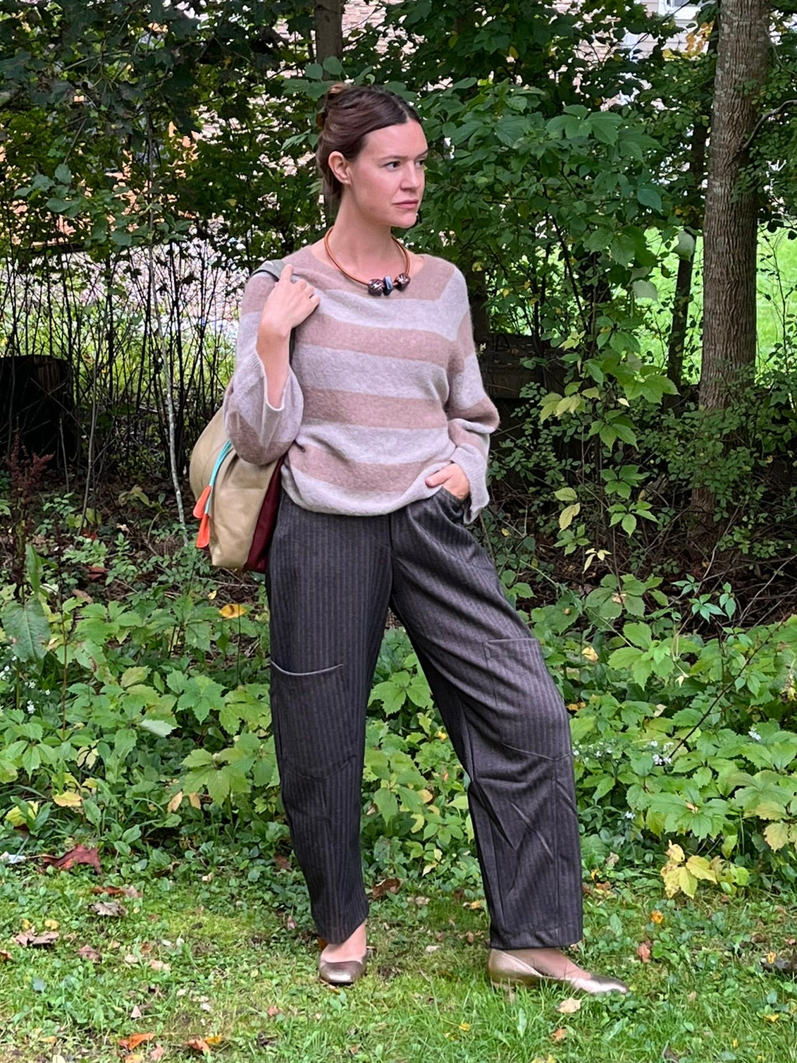 Cari wearing the Alembika Latte stripe sweater with Alembika taupe pants, a Soruka Celine shoulder bag and Zsiska Bliss necklace