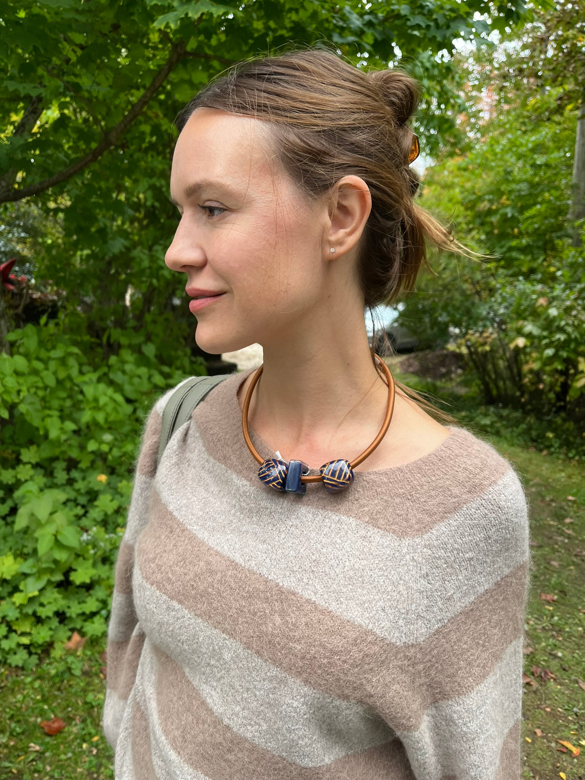 Cari wearing the Alembika Latte stripe sweater with Alembika taupe pants, a Soruka Celine shoulder bag and Zsiska Bliss necklace