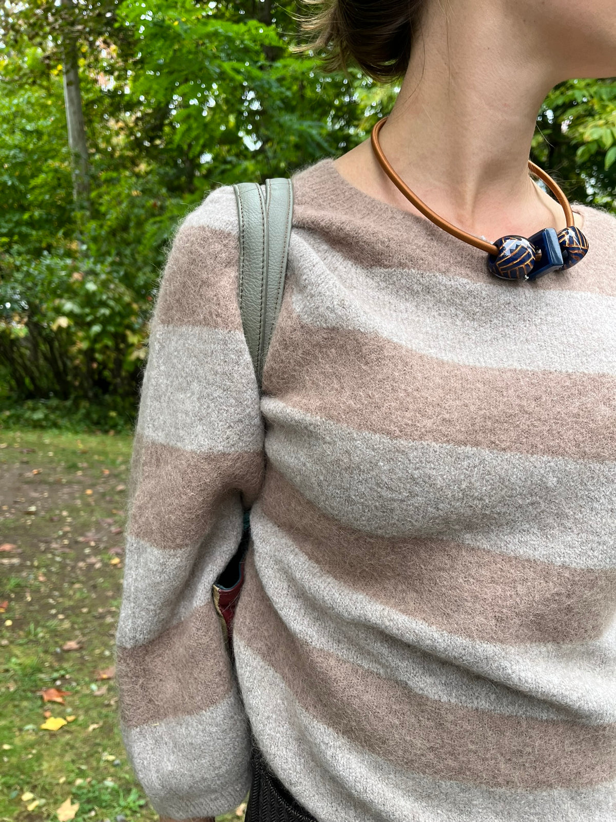 Cari wearing the Alembika Latte stripe sweater with Alembika taupe pants, a Soruka Celine shoulder bag and Zsiska Bliss necklace