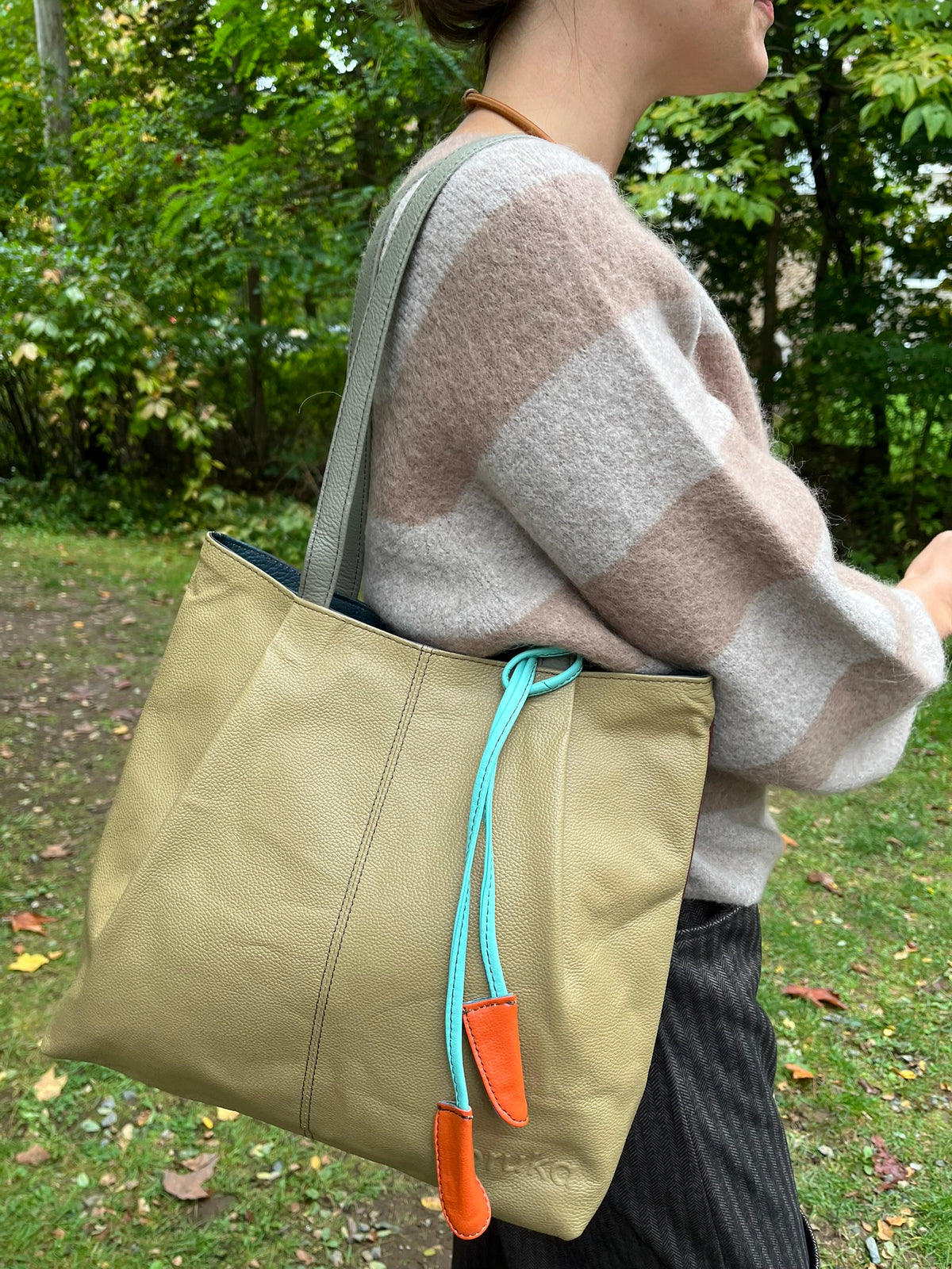 Cari wearing the Alembika Latte stripe sweater with Alembika taupe pants, a Soruka Celine shoulder bag and Zsiska Bliss necklace