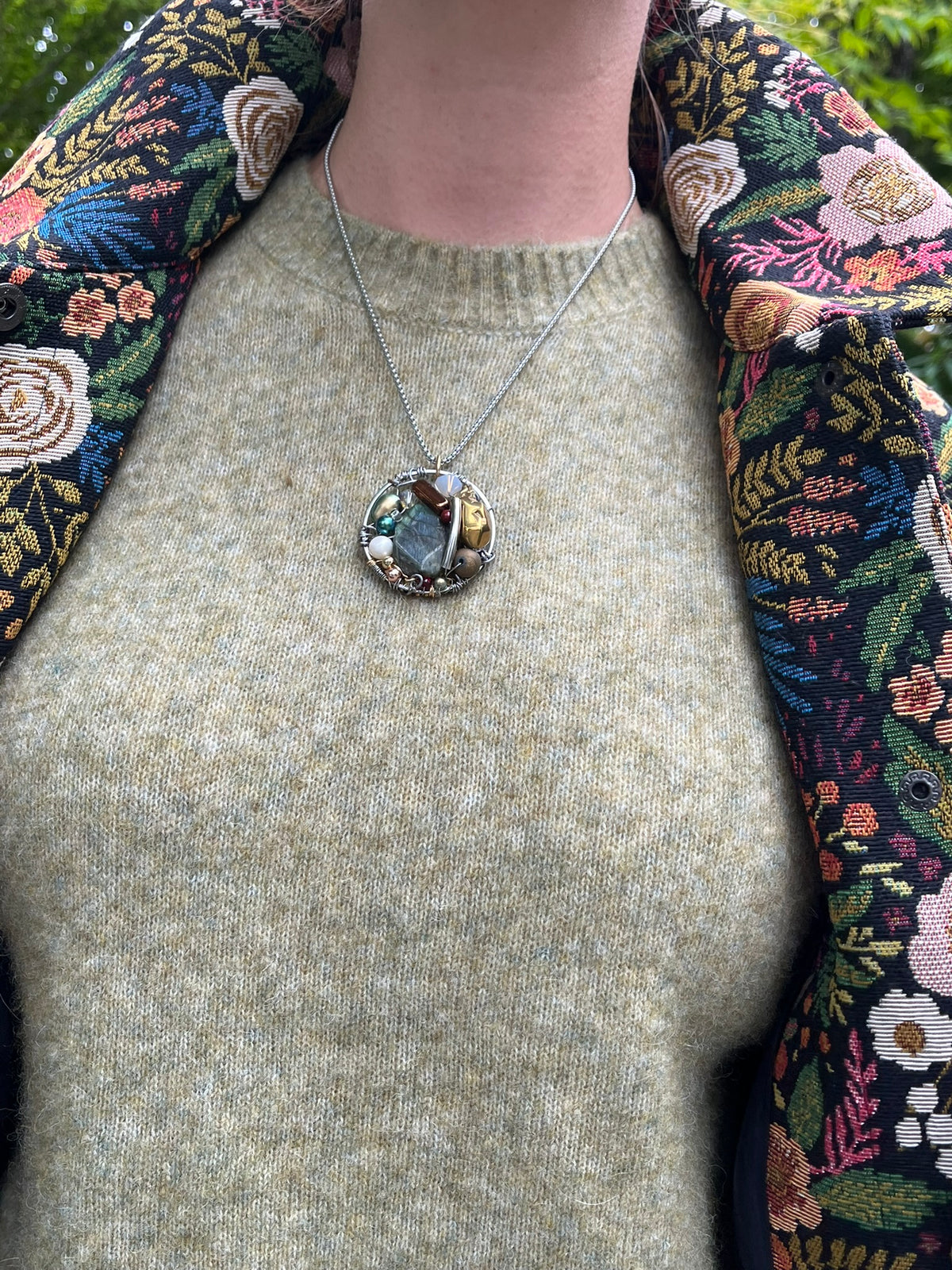 Cari wearing the Minus Meg jacket in black floral with the Minus Cheryl knit in fir green, FDJ Olivia slim ankle jeans and a Milo leather purse
