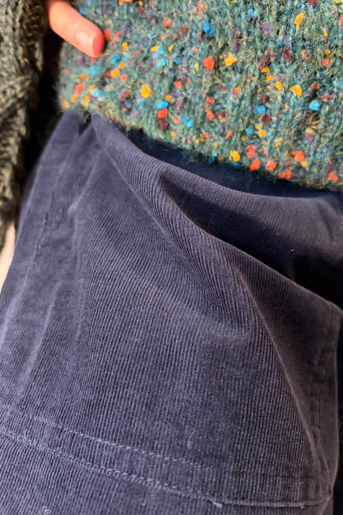 Cari wearing the Aran Crafts Innisfree funnel neck sweater over the White Stuff Texture V Neck Sweater with Seasalt Sholl cord trousers