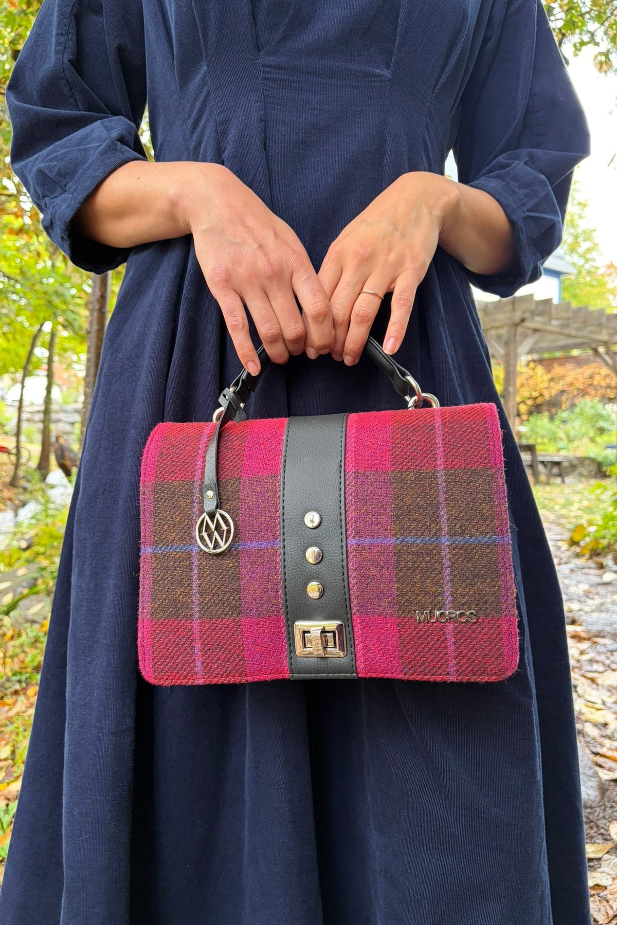 Cari wearing the White Stuff Kate Cord Dress by the stream with the pink plaid Mucros Fiona bag and Spring Moon Starry Night necklace