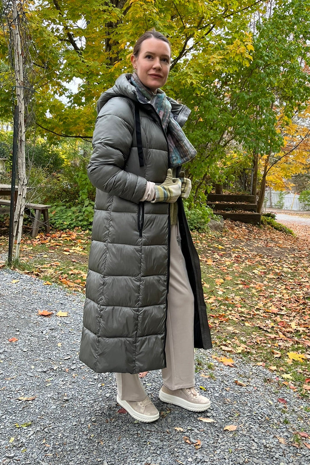 Cari wearing the Normann long hooded puffer coat in sage over a FOIL jacket, Minus Cheryl knit and FOIL Smooth Talker pants, with a Tresart silk muffler scarf and LUV & Co. gloves