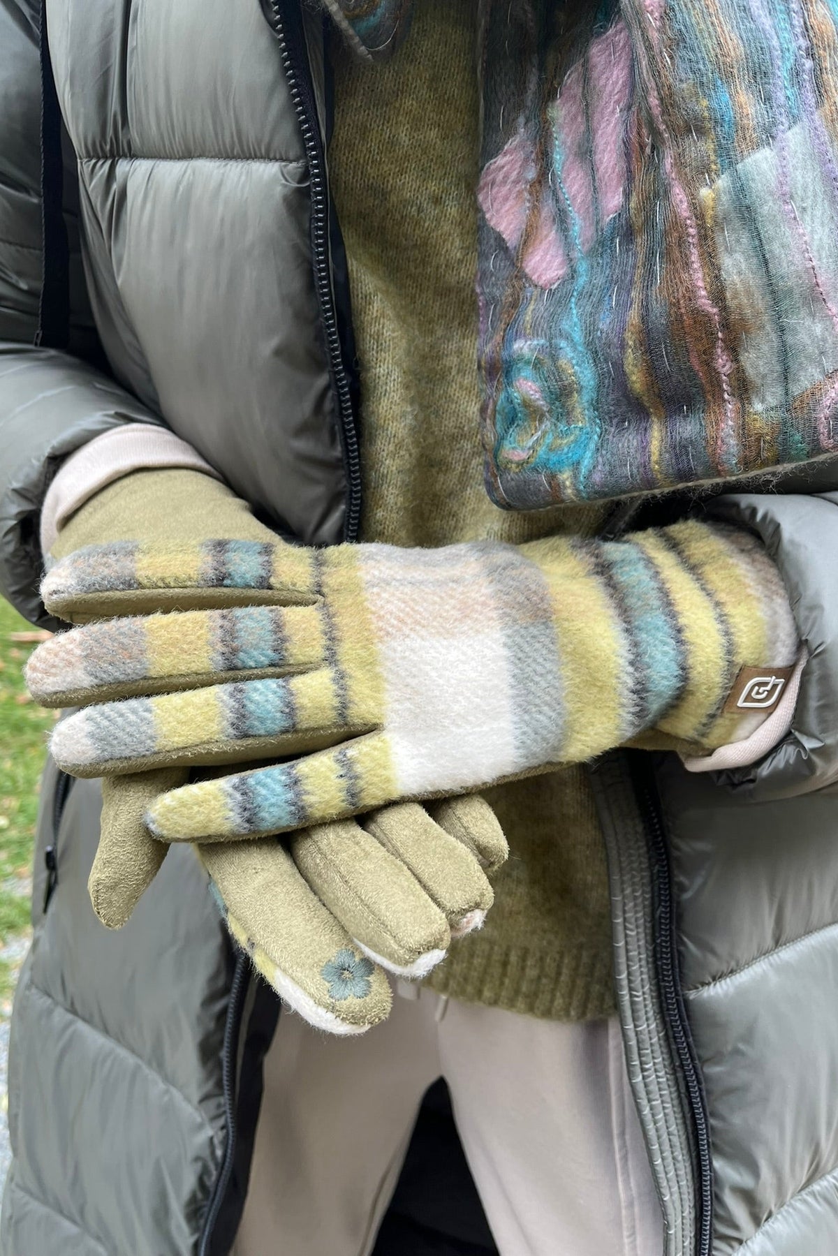 Cari wearing the Normann long hooded puffer coat in sage over a FOIL jacket, Minus Cheryl knit and FOIL Smooth Talker pants, with a Tresart silk muffler scarf and LUV & Co. gloves