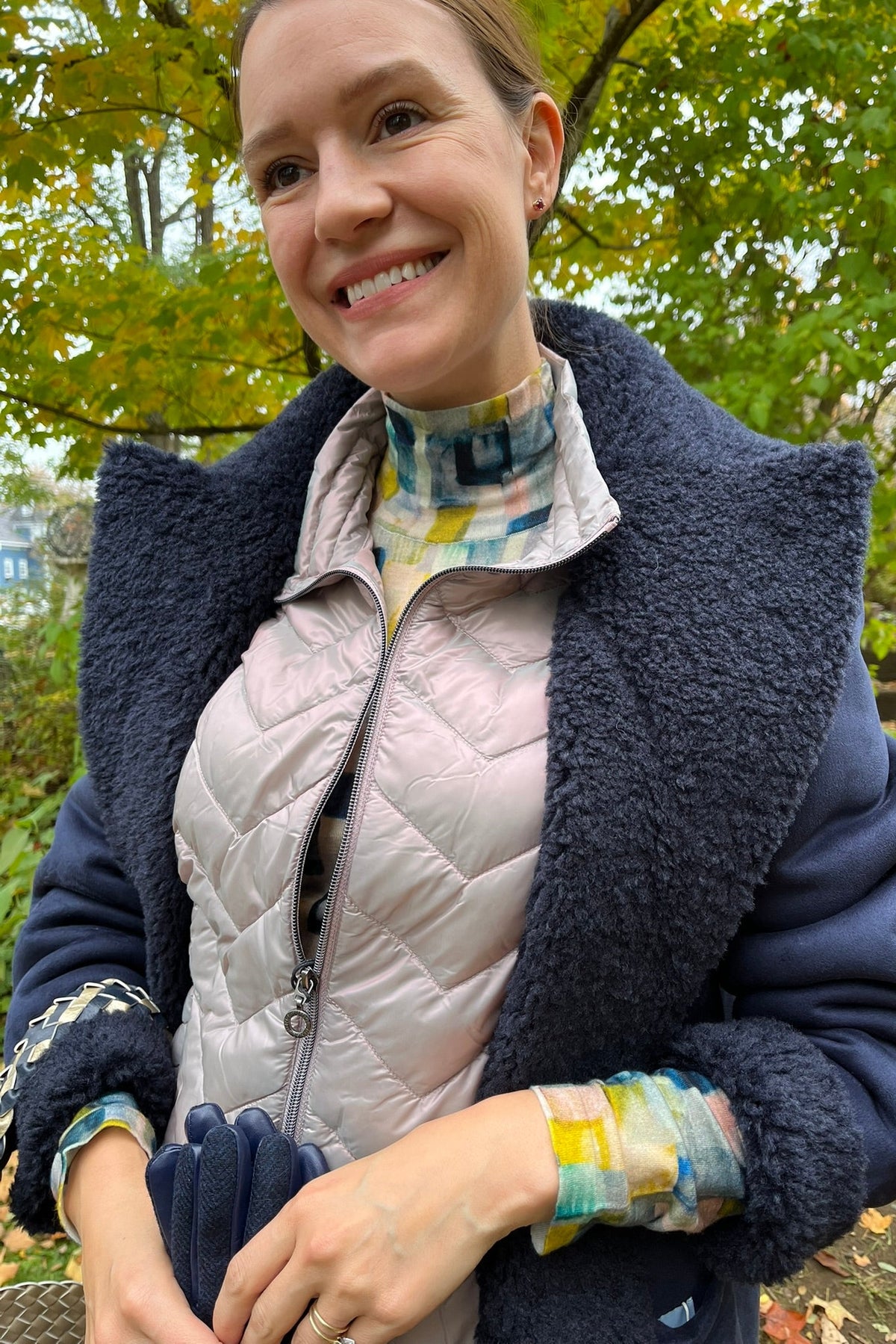 Cari wearing the Minus Alda faux fur jacket over a rose Junge Louise vest, Mansted Melina print polo neck and Carreli navy cords, with an Ilse Jacobsen braided shopper and Brume gloves