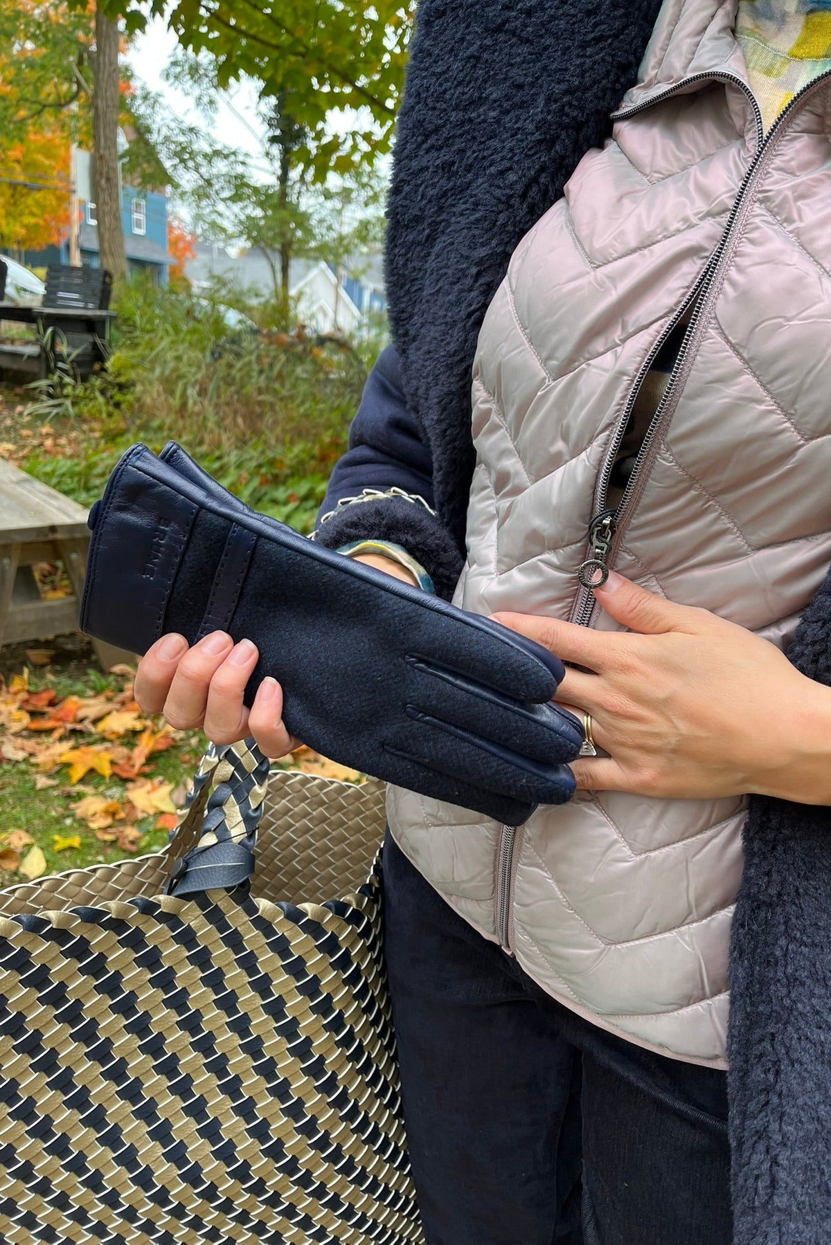 Cari wearing the Minus Alda faux fur jacket over a rose Junge Louise vest, Mansted Melina print polo neck and Carreli navy cords, with an Ilse Jacobsen braided shopper and Brume gloves