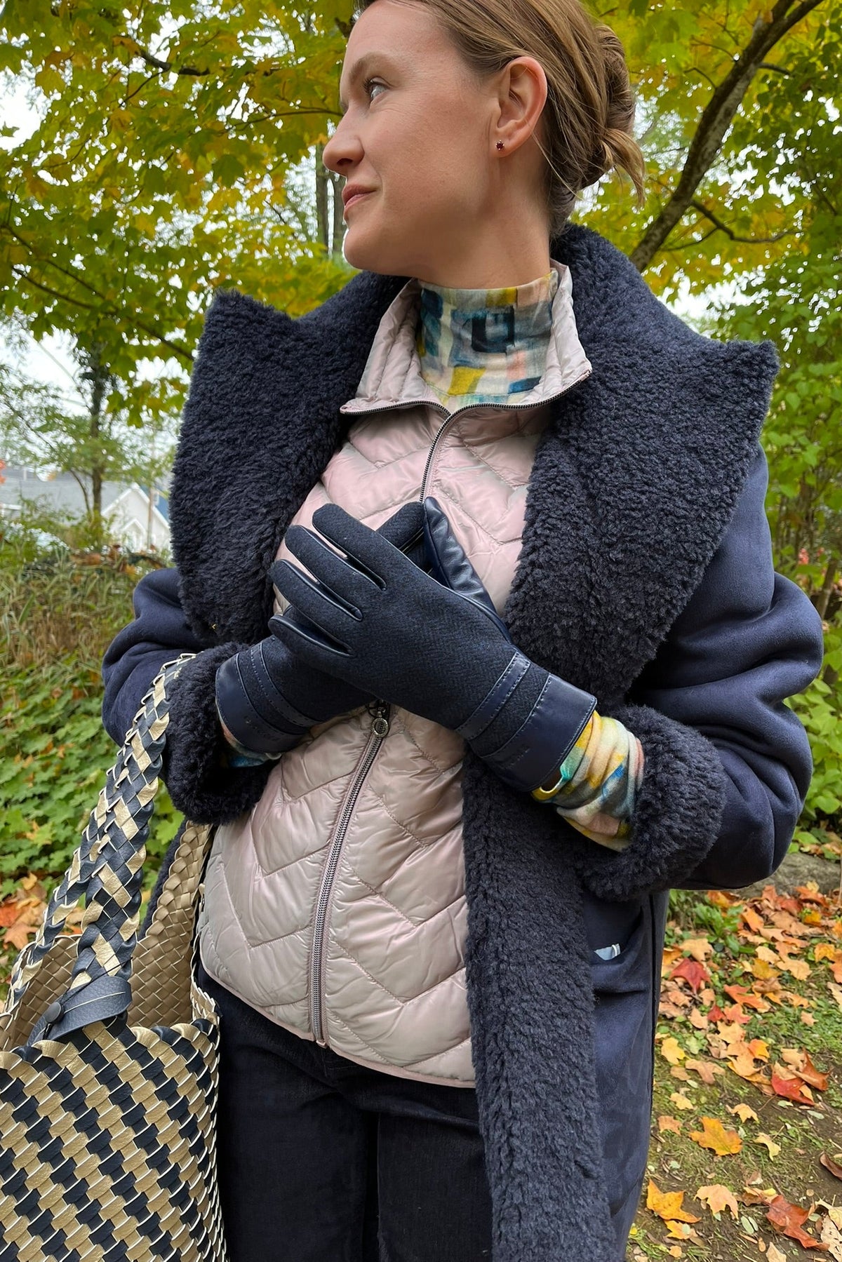 Cari wearing the Minus Alda faux fur jacket over a rose Junge Louise vest, Mansted Melina print polo neck and Carreli navy cords, with an Ilse Jacobsen braided shopper and Brume gloves
