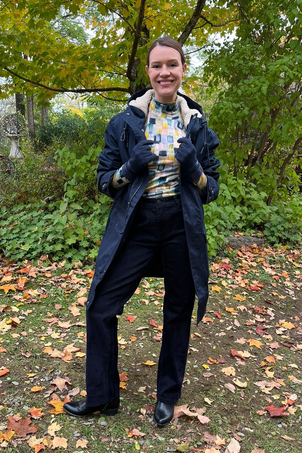 Cari wearing the navy Seasalt Tidesman coat over a Mansted Melina print polo neck and Carreli navy cords, with Brume Waterloo gloves