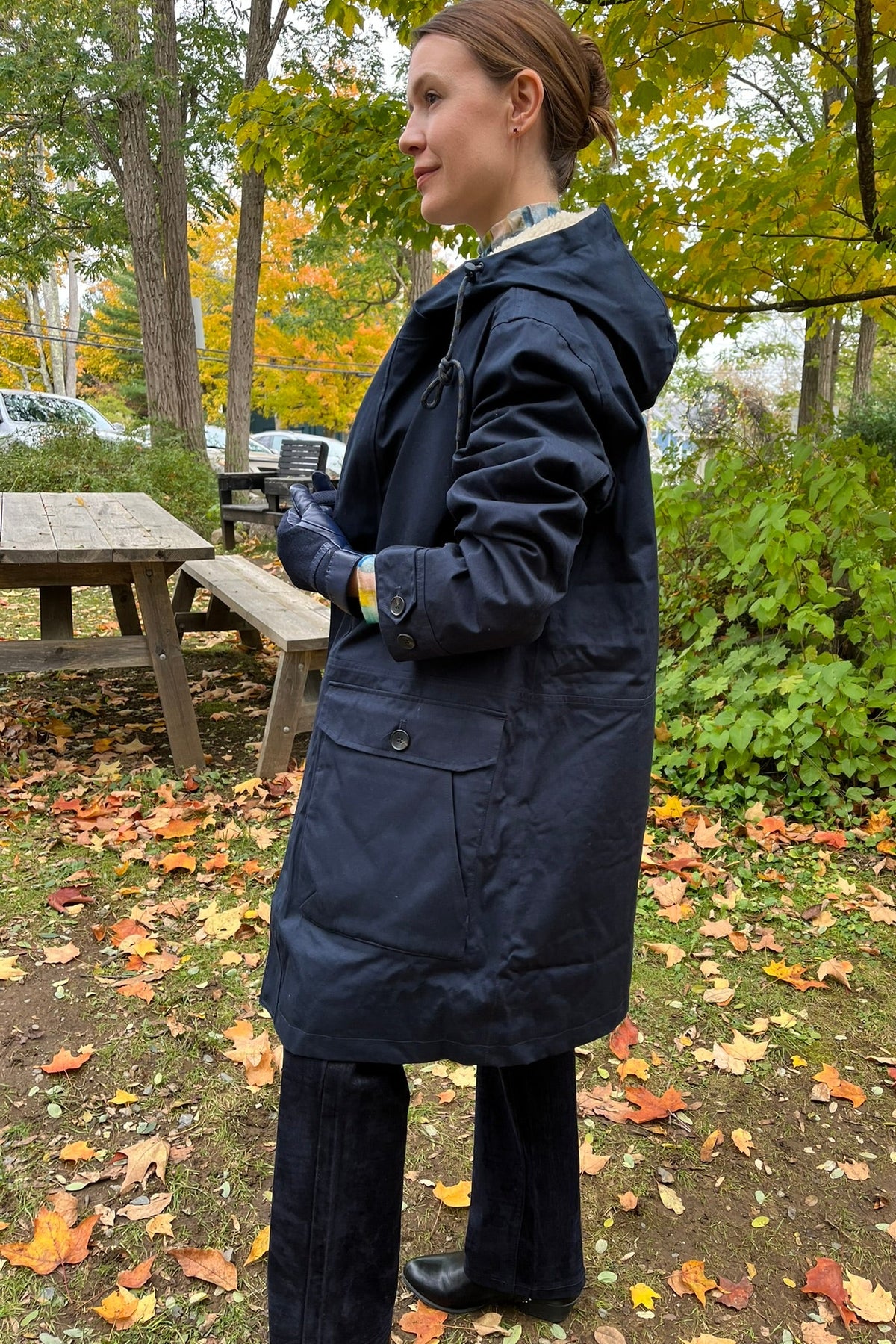 Cari wearing the navy Seasalt Tidesman coat over a Mansted Melina print polo neck and Carreli navy cords, with Brume Waterloo gloves