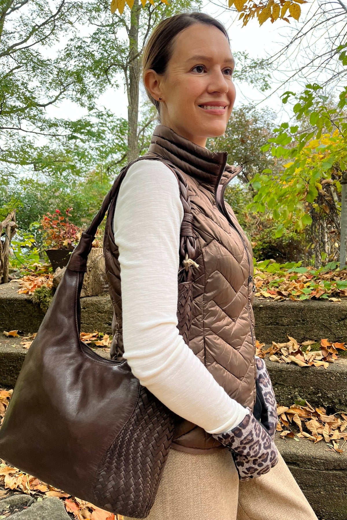Cari wearing the Junge Louise down vest in brown over a Minus Cally roll neck and Wit & Wisdom Whitney trousers, with the Milo Albany bag and LUV & Co. leopard gloves