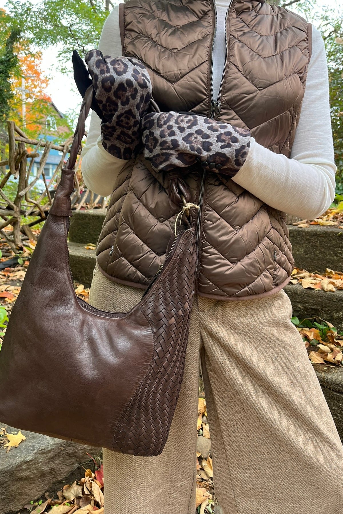 Cari wearing the Junge Louise down vest in brown over a Minus Cally roll neck and Wit & Wisdom Whitney trousers, with the Milo Albany bag and LUV & Co. leopard gloves