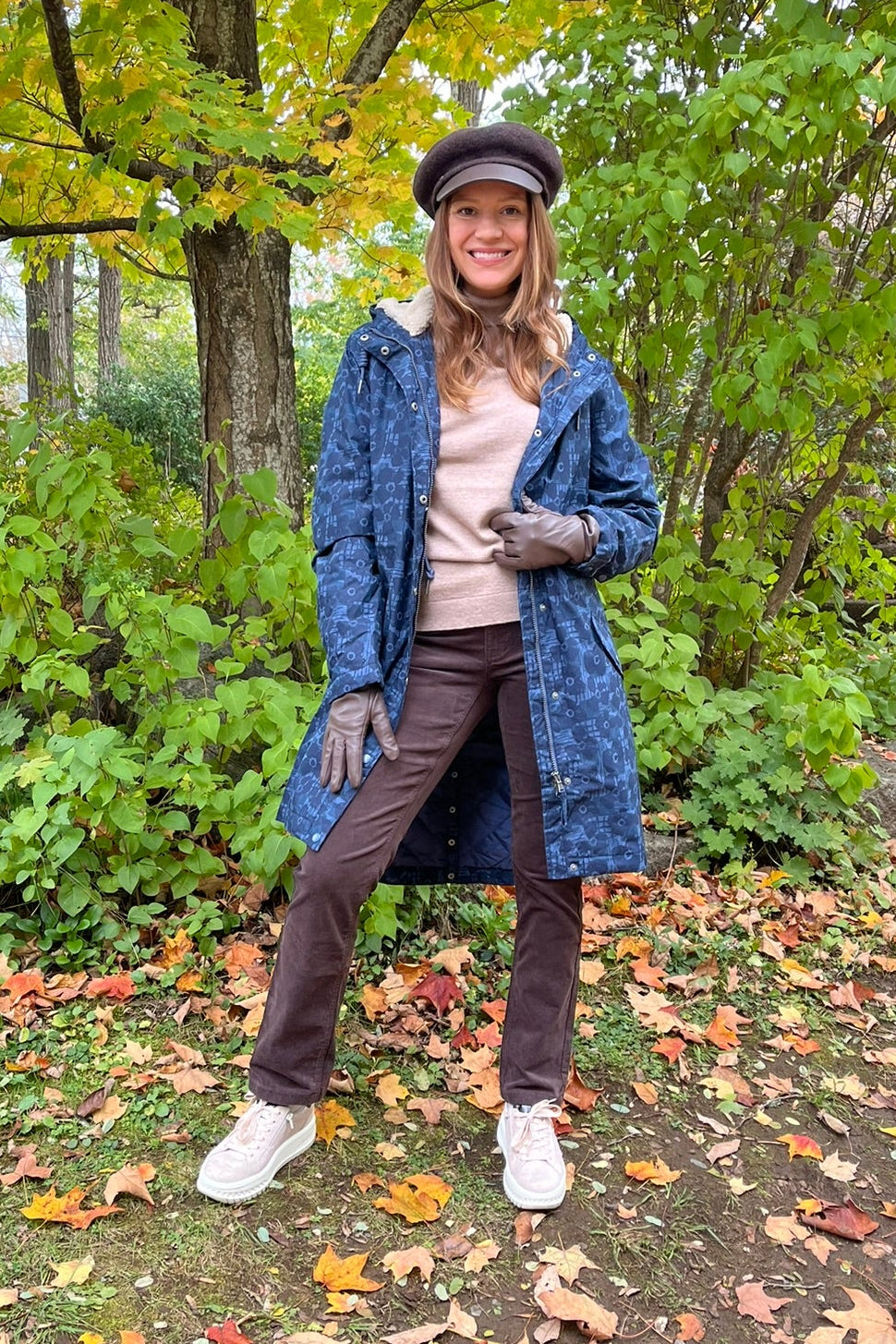 Cari wearing the Seasalt Plant Hunter raincoat in Squall print, B. Copenhagen turtleneck and Carreli chocolate cords, with a Loevenich cap and Auclair Sofia gloves