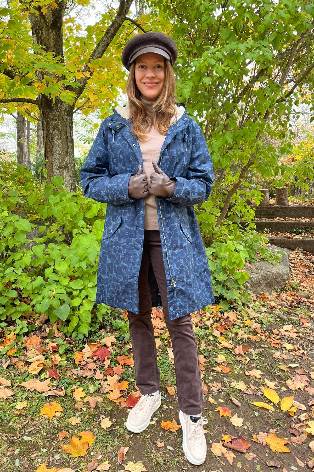 Cari wearing the Seasalt Plant Hunter raincoat in Squall print, B. Copenhagen turtleneck and Carreli chocolate cords, with a Loevenich cap and Auclair Sofia gloves