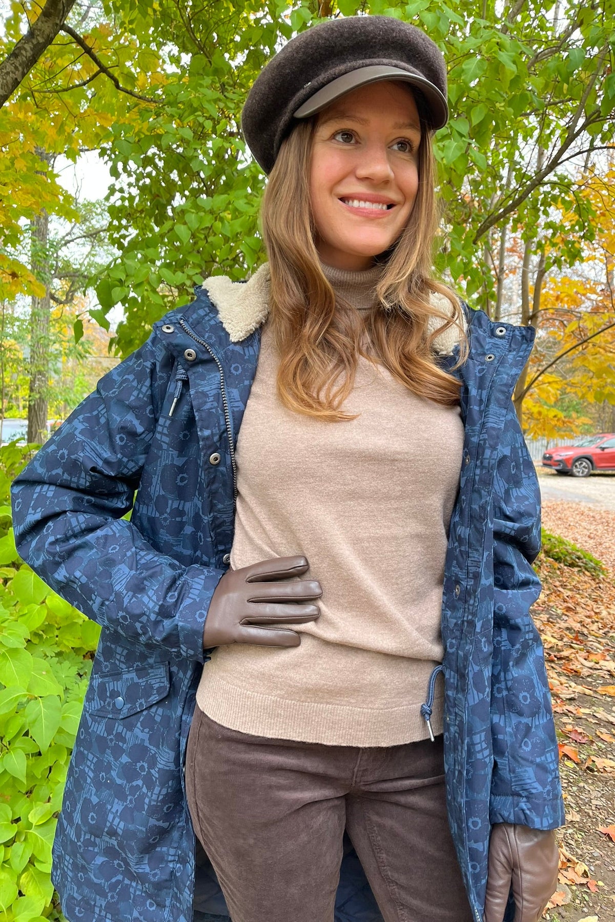 Cari wearing the Seasalt Plant Hunter raincoat in Squall print, B. Copenhagen turtleneck and Carreli chocolate cords, with a Loevenich cap and Auclair Sofia gloves