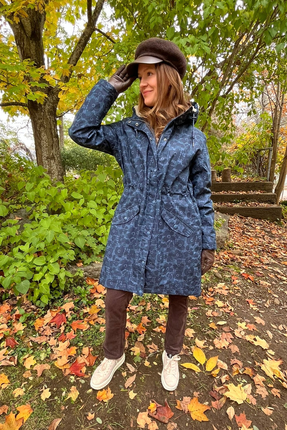 Cari wearing the Seasalt Plant Hunter raincoat in Squall print, B. Copenhagen turtleneck and Carreli chocolate cords, with a Loevenich cap and Auclair Sofia gloves