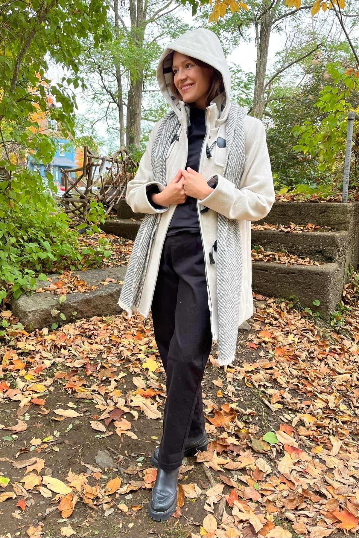 Cari wearing the Junge Sophie duffel coat in ecru with a Mucros Aran scarf, Dolcezza black mock neck top and Seasalt Waterdance trousers