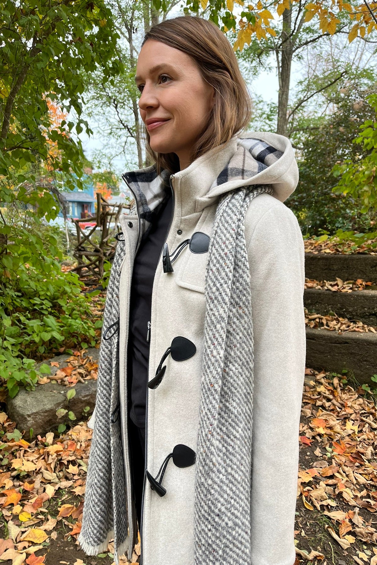 Cari wearing the Junge Sophie duffel coat in ecru with a Mucros Aran scarf, Dolcezza black mock neck top and Seasalt Waterdance trousers