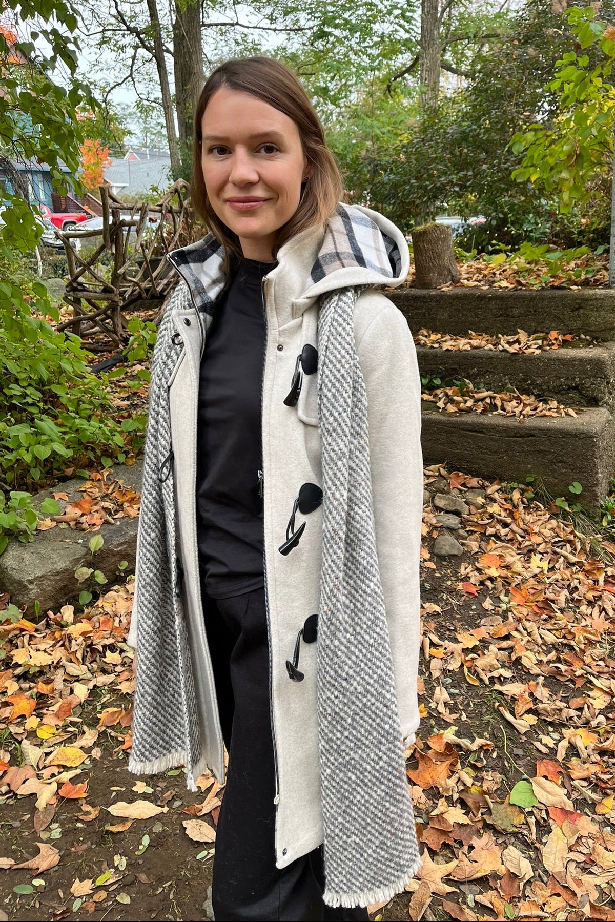 Cari wearing the Junge Sophie duffel coat in ecru with a Mucros Aran scarf, Dolcezza black mock neck top and Seasalt Waterdance trousers