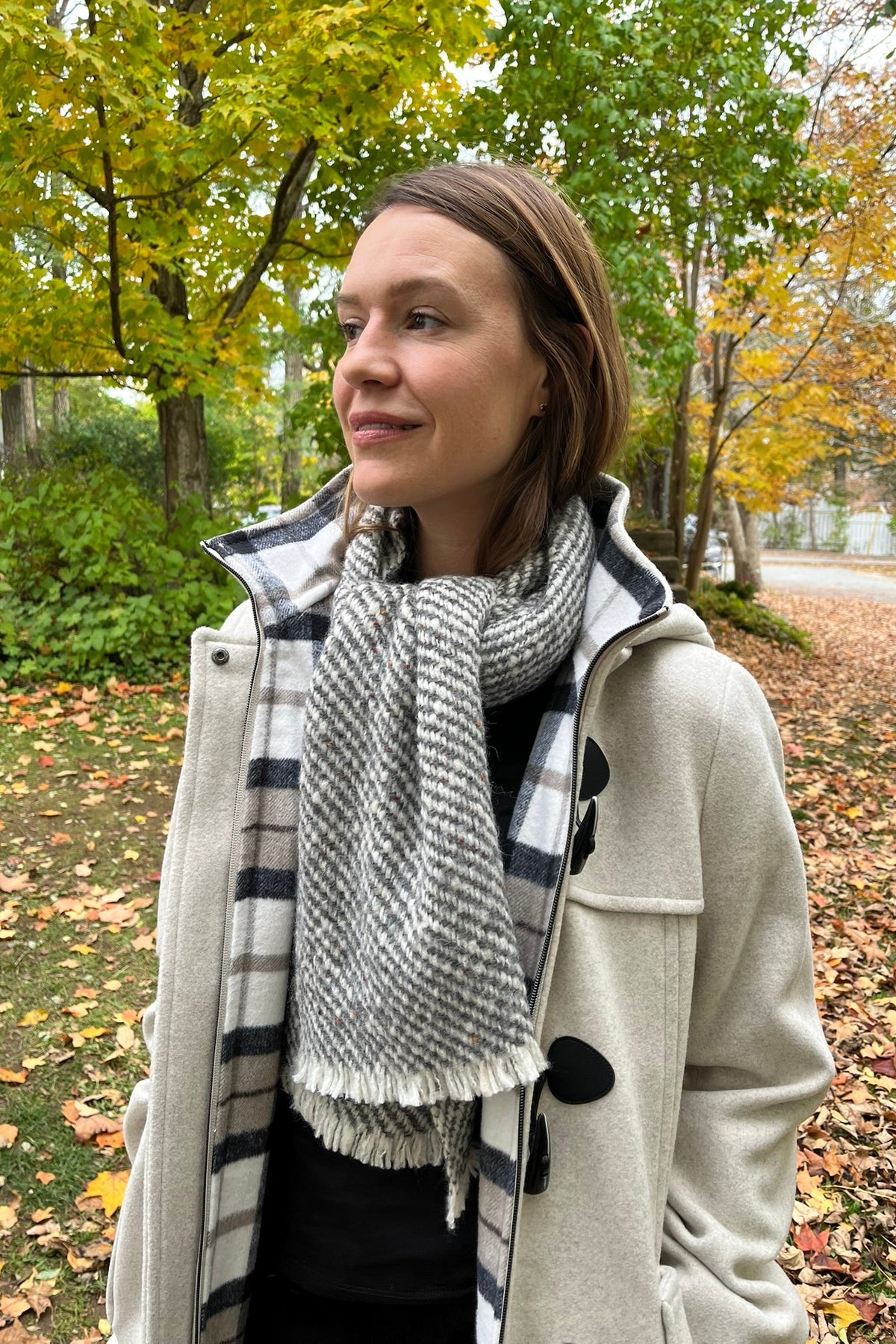 Cari wearing the Junge Sophie duffel coat in ecru with a Mucros Aran scarf, Dolcezza black mock neck top and Seasalt Waterdance trousers