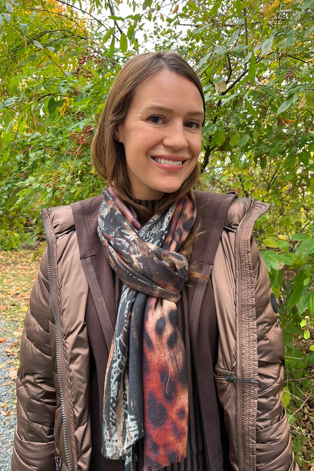 Cari wearing the Junge Phillipa down coat in brown over a Blue Sky Cortes jacket, LUUKAA stripe pullover and HUE leggings, with a LUV & Co. wool silk scarf, alpaca pompom hat and LUV & Co. gloves