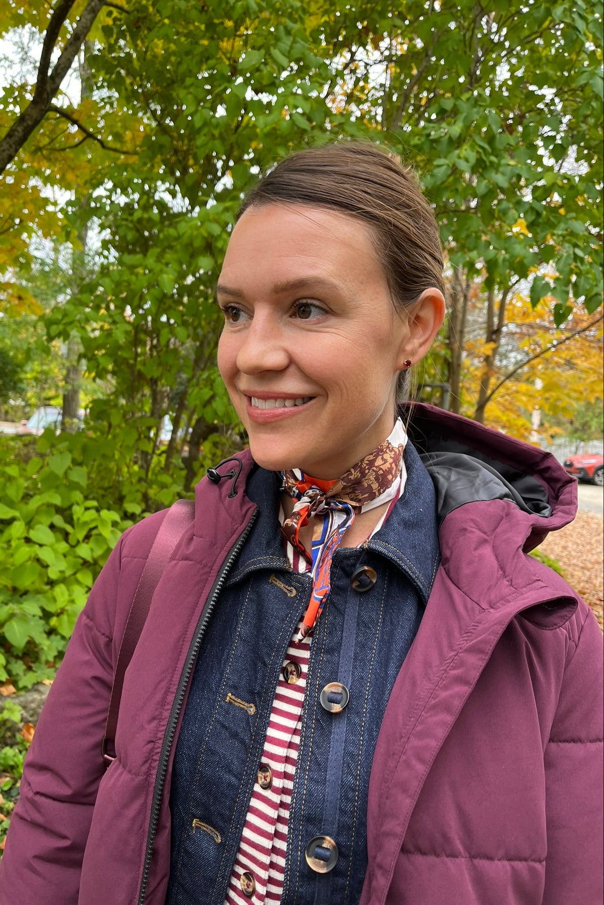 Cari wearing the Normann mid calf puffer in plum over a White Stuff Eden denim jacket, Imogen shirt and Tia jeans, with a Skyla crossbody bag and Lyla + Luxe skinny scarf