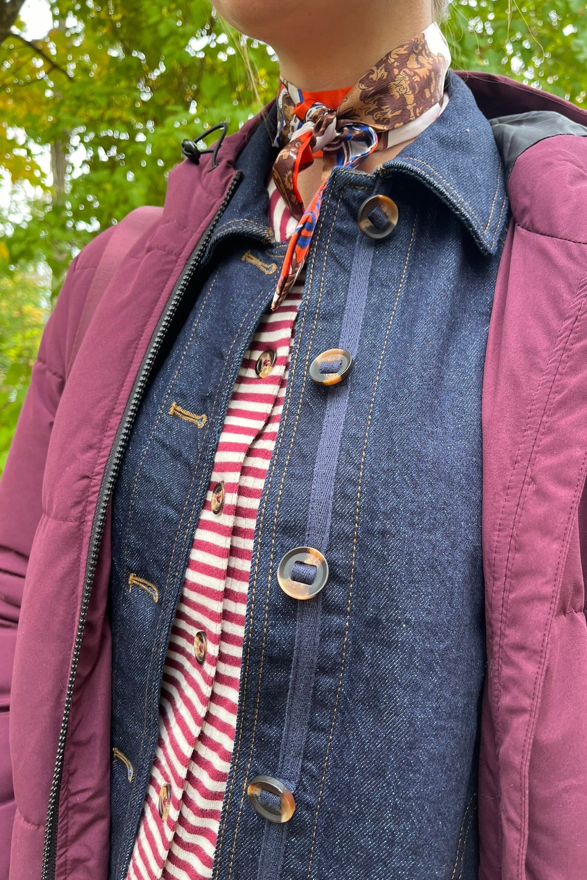 Cari wearing the Normann mid calf puffer in plum over a White Stuff Eden denim jacket, Imogen shirt and Tia jeans, with a Skyla crossbody bag and Lyla + Luxe skinny scarf