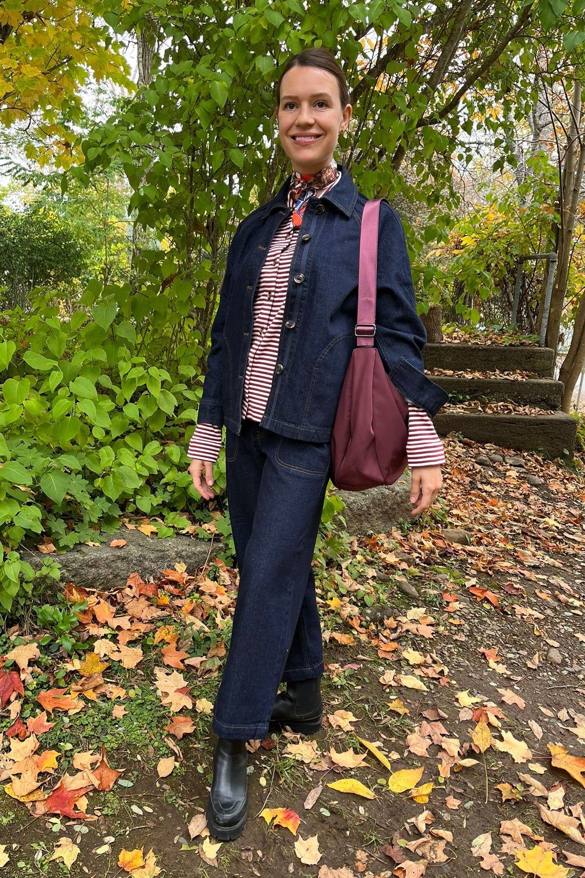 Cari wearing the Normann mid calf puffer in plum over a White Stuff Eden denim jacket, Imogen shirt and Tia jeans, with a Skyla crossbody bag and Lyla + Luxe skinny scarf
