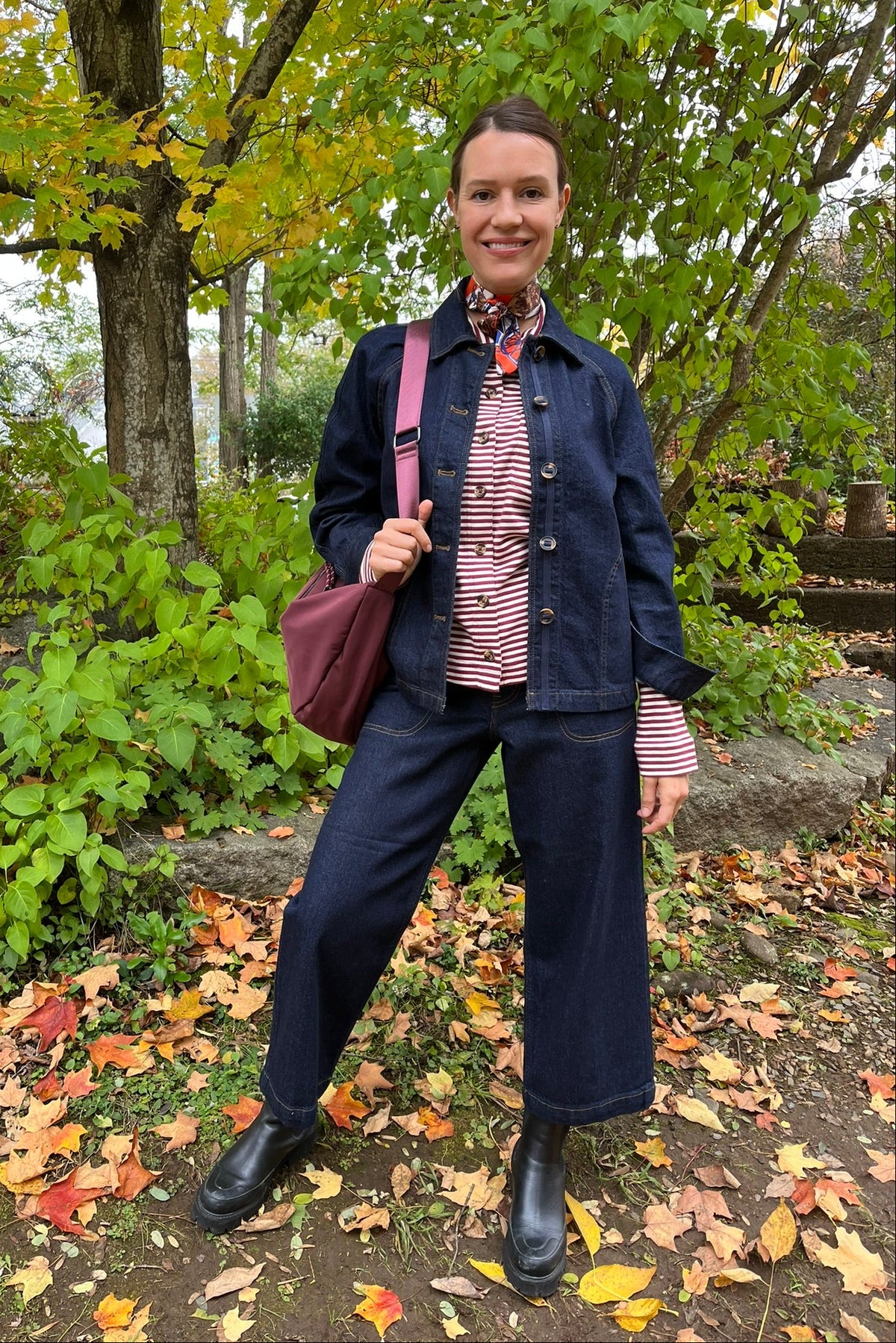Cari wearing the Normann mid calf puffer in plum over a White Stuff Eden denim jacket, Imogen shirt and Tia jeans, with a Skyla crossbody bag and Lyla + Luxe skinny scarf