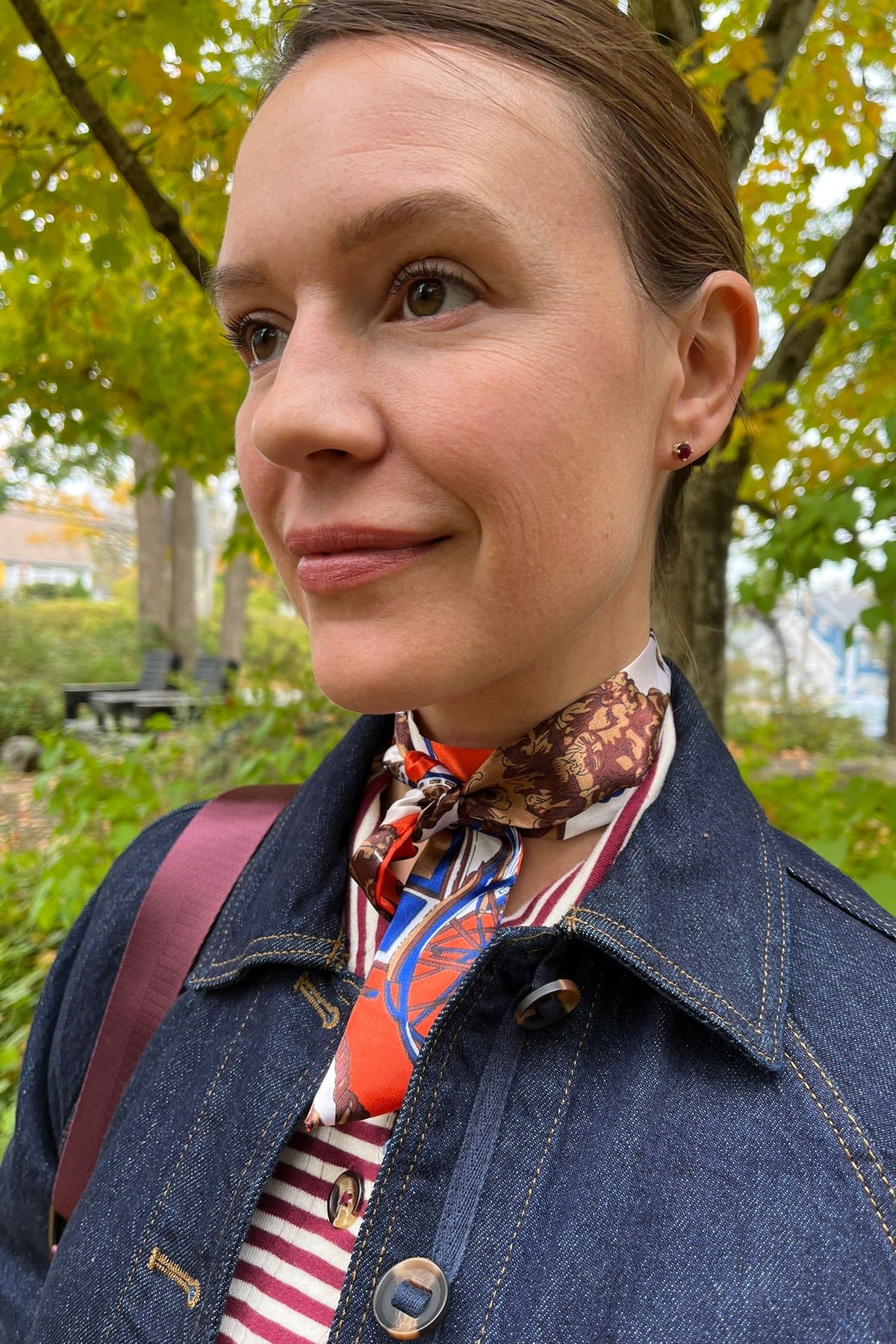 Cari wearing the Normann mid calf puffer in plum over a White Stuff Eden denim jacket, Imogen shirt and Tia jeans, with a Skyla crossbody bag and Lyla + Luxe skinny scarf