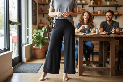 A model wearing black wide-leg palazzo pants with a grey top