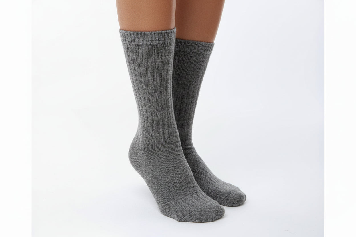 Beige socks worn by a person on a white background