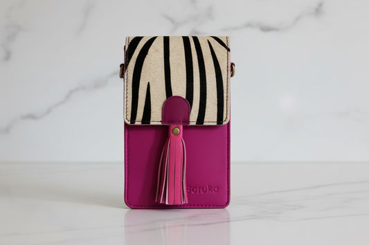 pink phone case bag with shoulder strap and front flap opening in black and white zebra print 