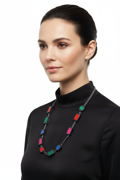Necklace with colorful rectangular and round beads on a white background