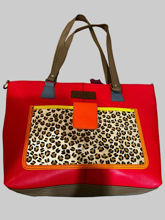 Red handbag with leopard print section and pocket on front