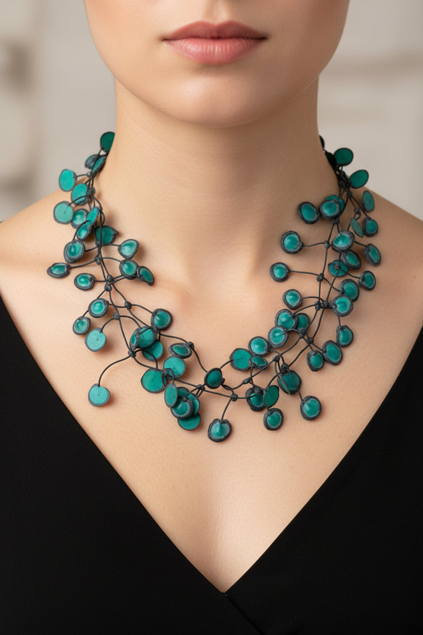 green beaded necklace on a white background