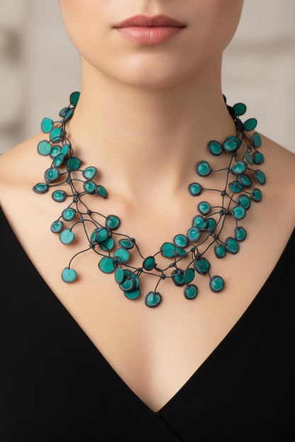 green beaded necklace on a white background