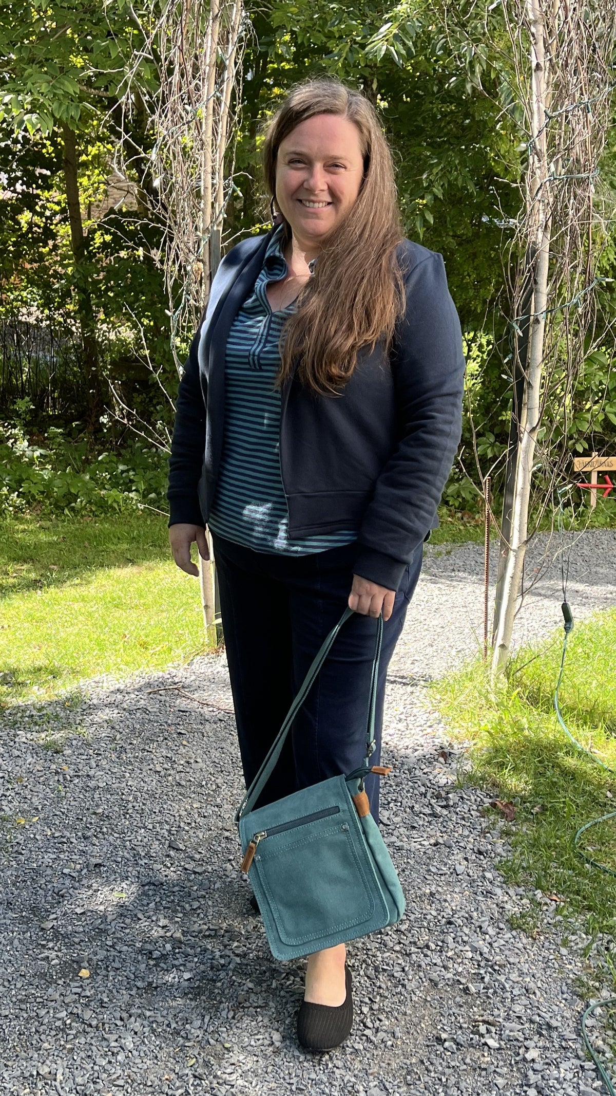 Alma wearing the Blondie Apparel Spruce cardigan in navy over an Escape by Habitat teal top with Habitat denim pants