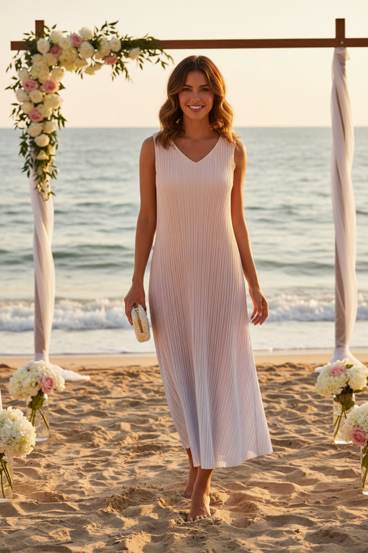 Beige and white pleated dress on a white background