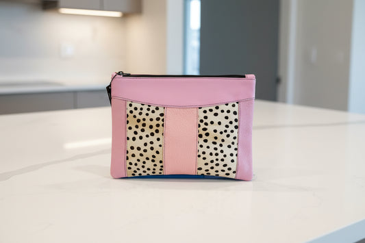 bag with animal pattern and pink leather accents on a counter top - side 1 of4