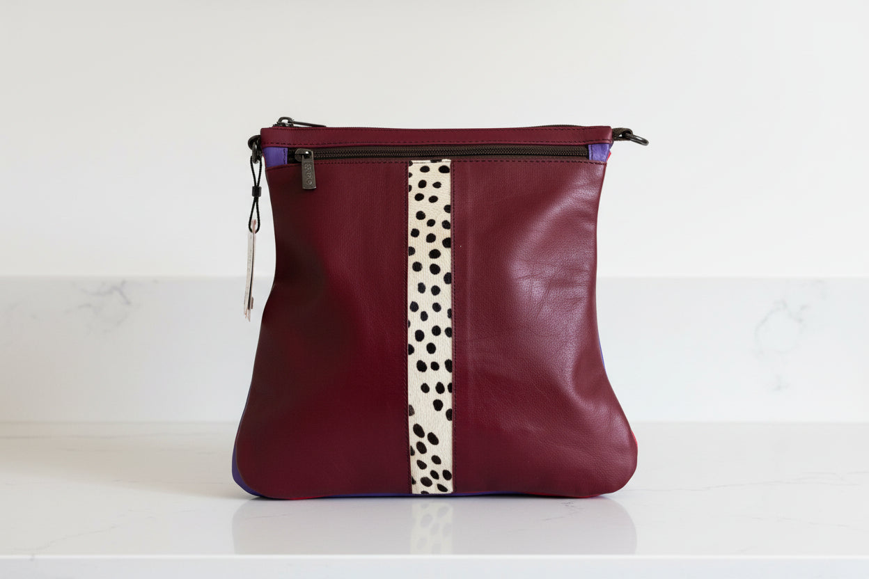 Maroon leather handbag side 1