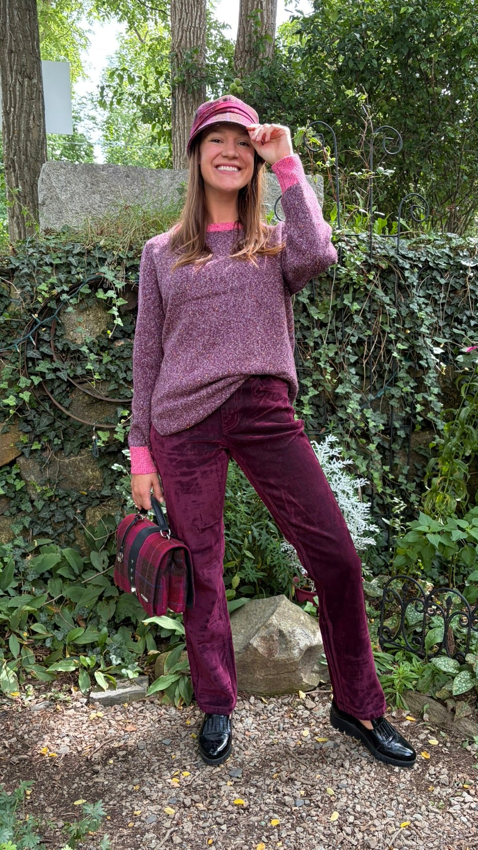 Cari wearing Carreli wine flock straight leg jeans with a White Stuff Talia jumper in plum and a Mucros Weavers Fiona bag