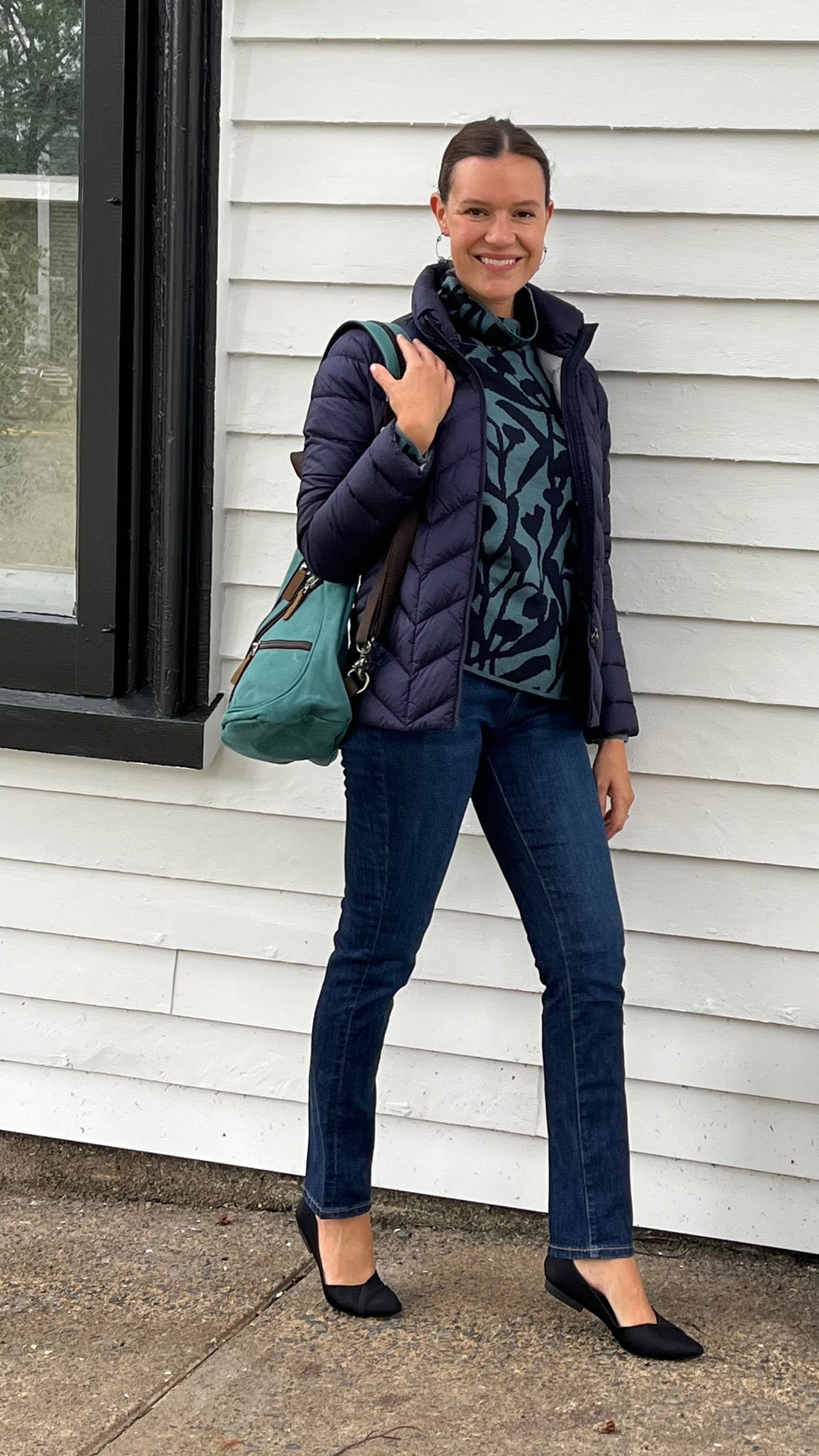 Cari in Lunenburg wearing the Mansted Nanna sweater in teal with a Junge Daisy down jacket, Yoga Jeans Emily jeans and Davan sling bag