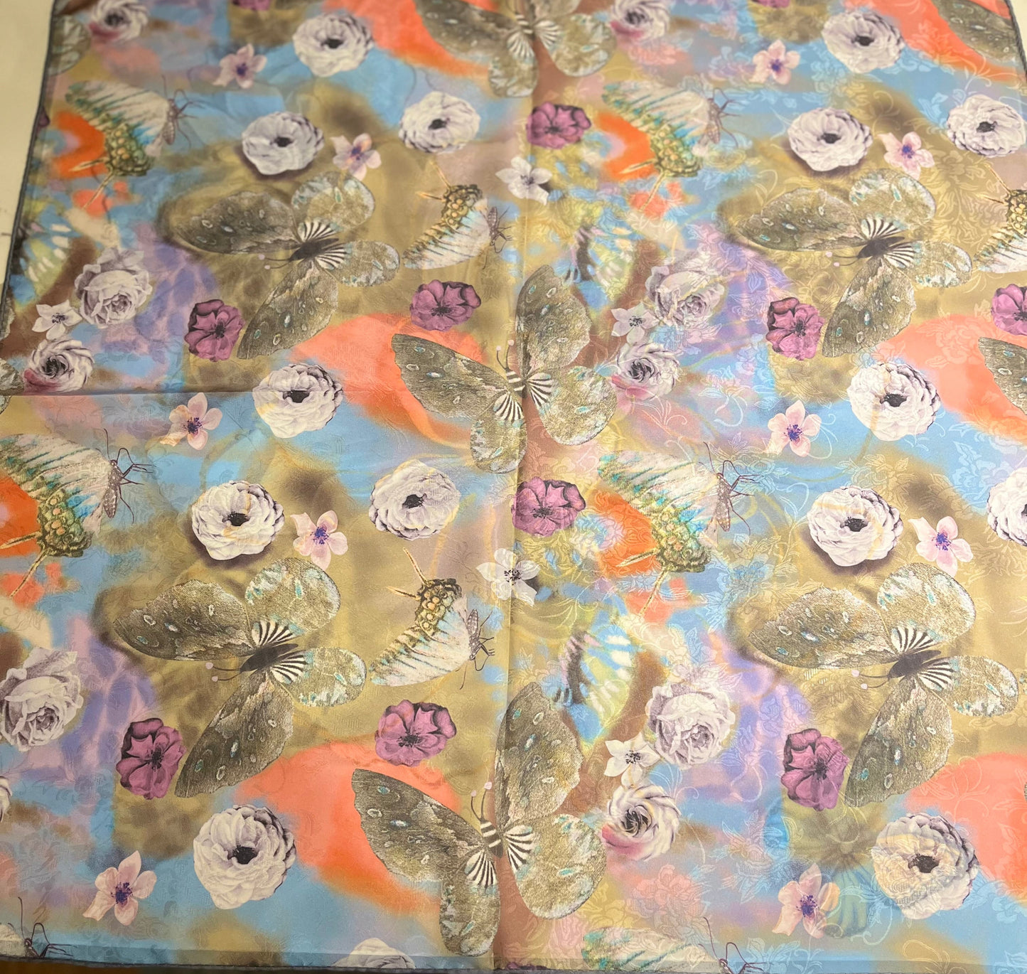 Decorative box with butterfly and floral pattern on a wooden surface